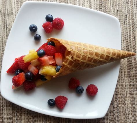 Waffle cones filled with ice cream and fruit
