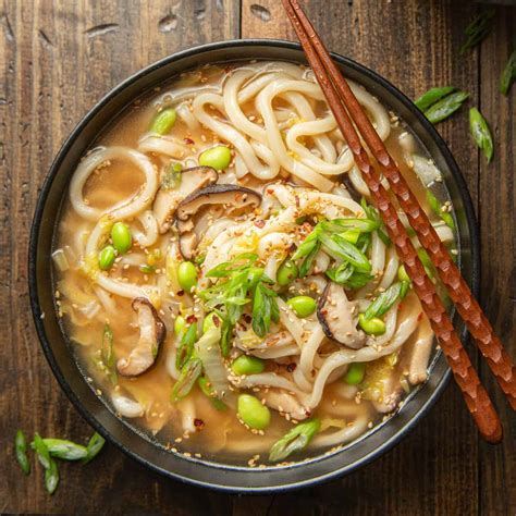 A bowl of hot Udon soup with shrimp and mushrooms