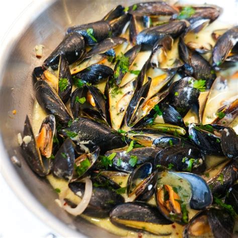 Mussels in a pot with herbs and white wine