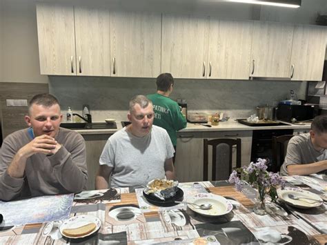 Žmonės bendraujantys prie stalo tamsoje