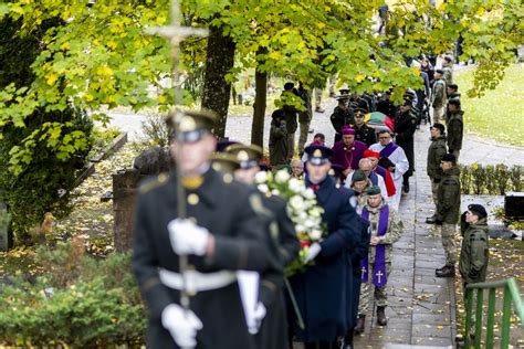 Laidotuvių ceremonija su urna ir gėlėmis